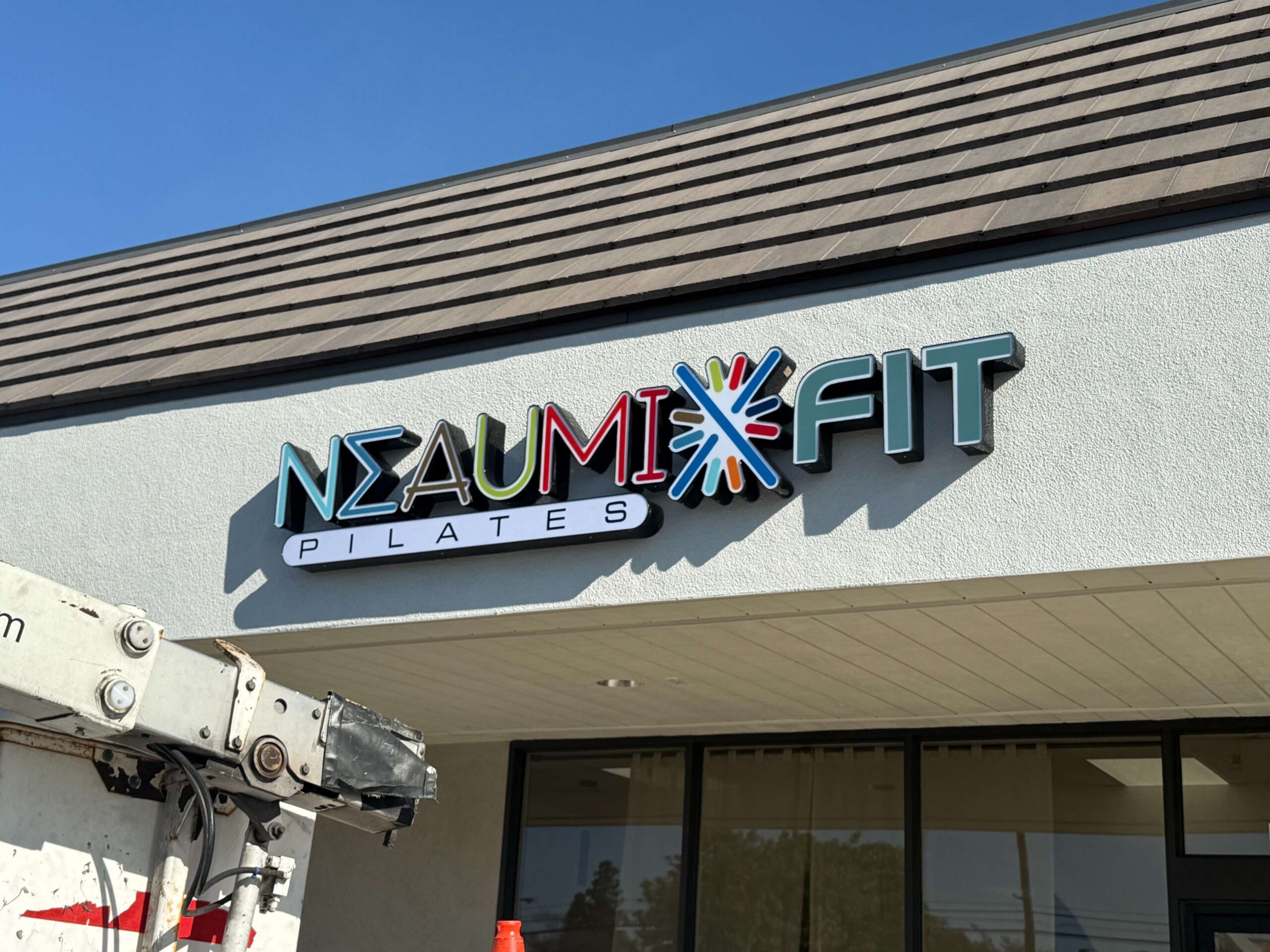 Custom illuminated exterior sign for Pilates studio in Orange County